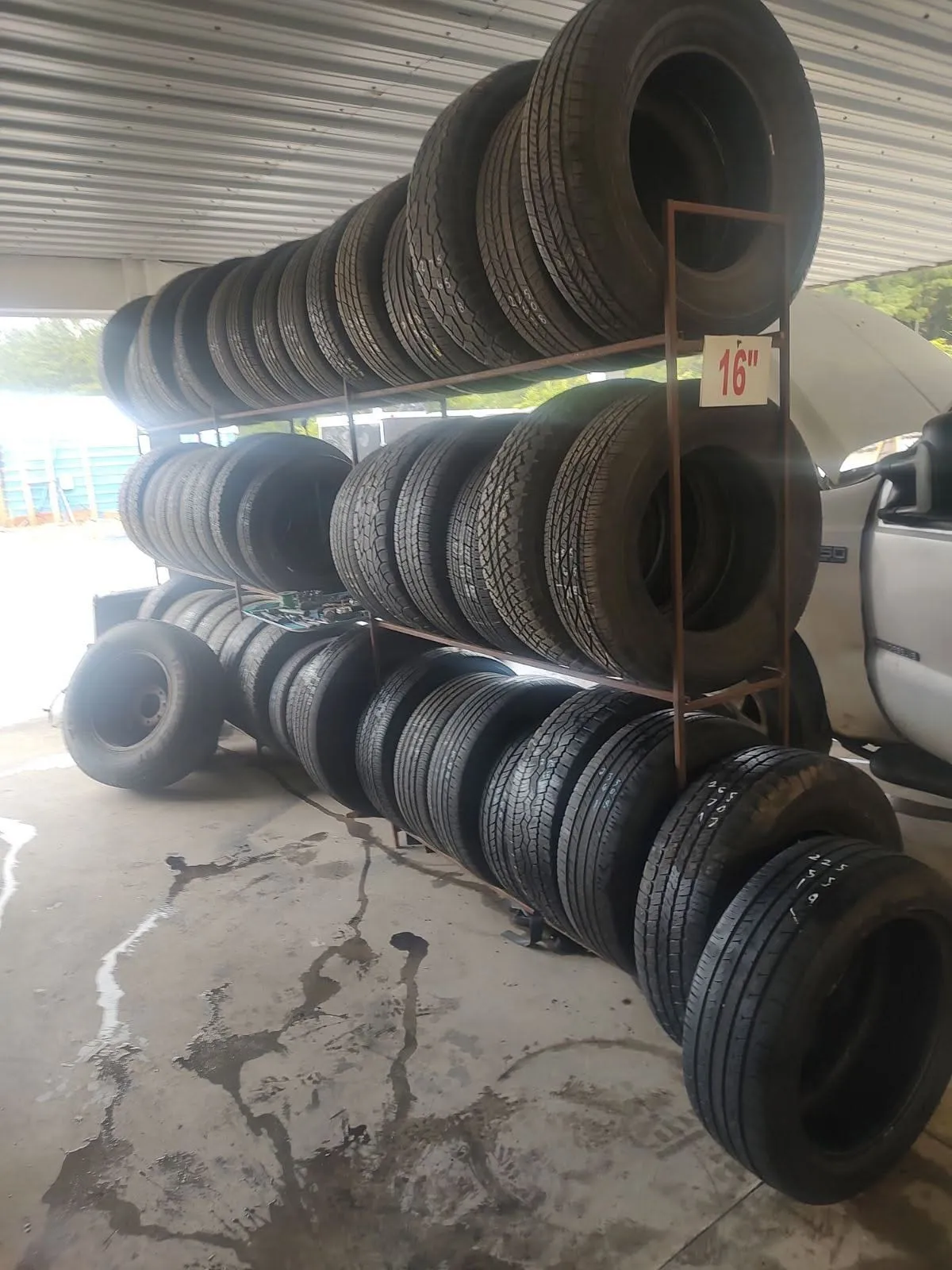 A rack of new and used tires organized by size at Riverside Automotive.